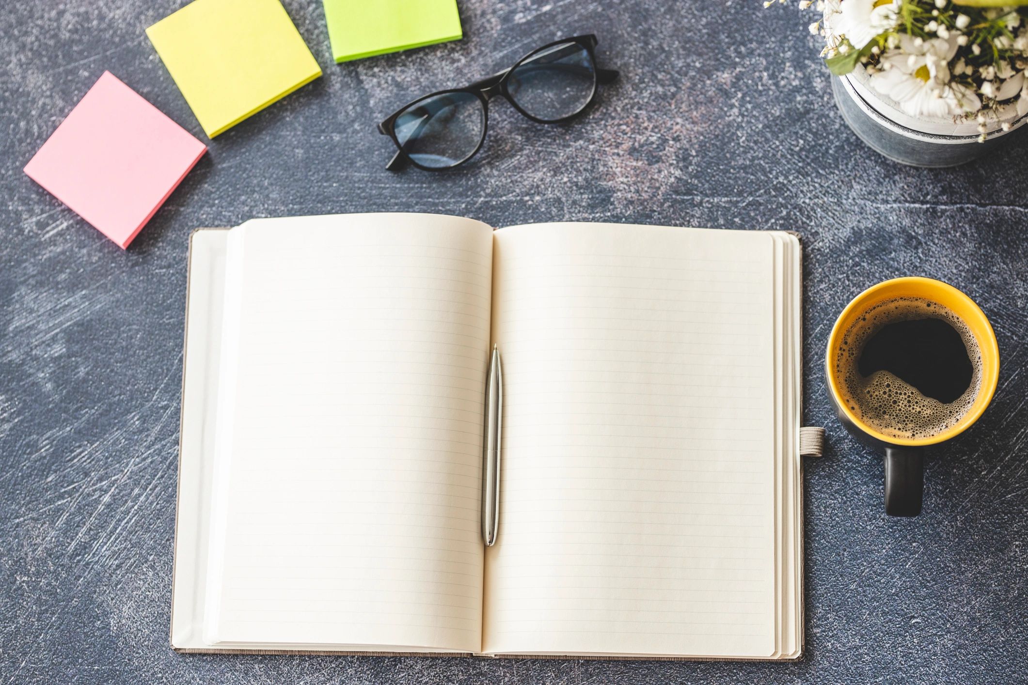 Notebook and coffee on a desk