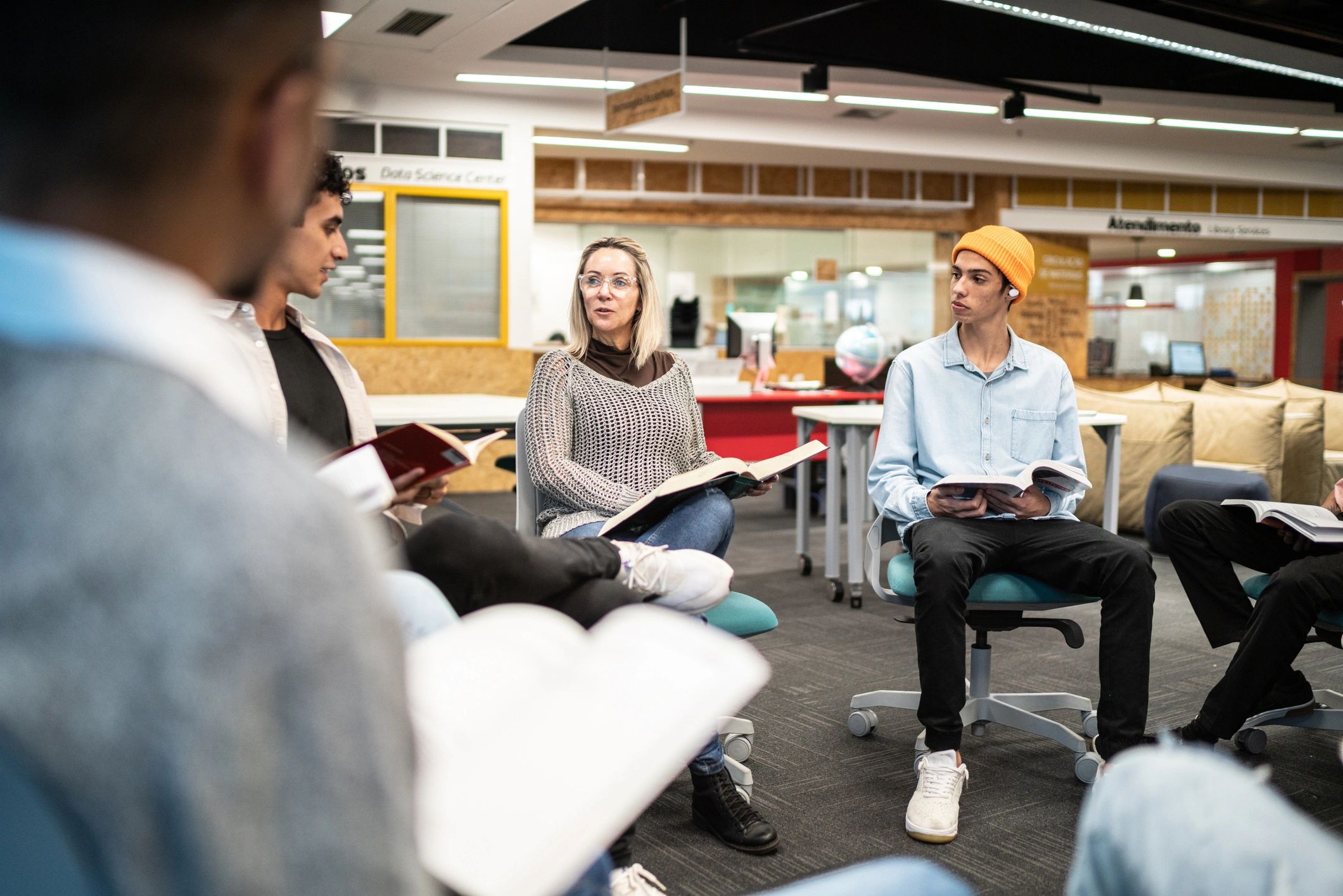 Two students reading a book together