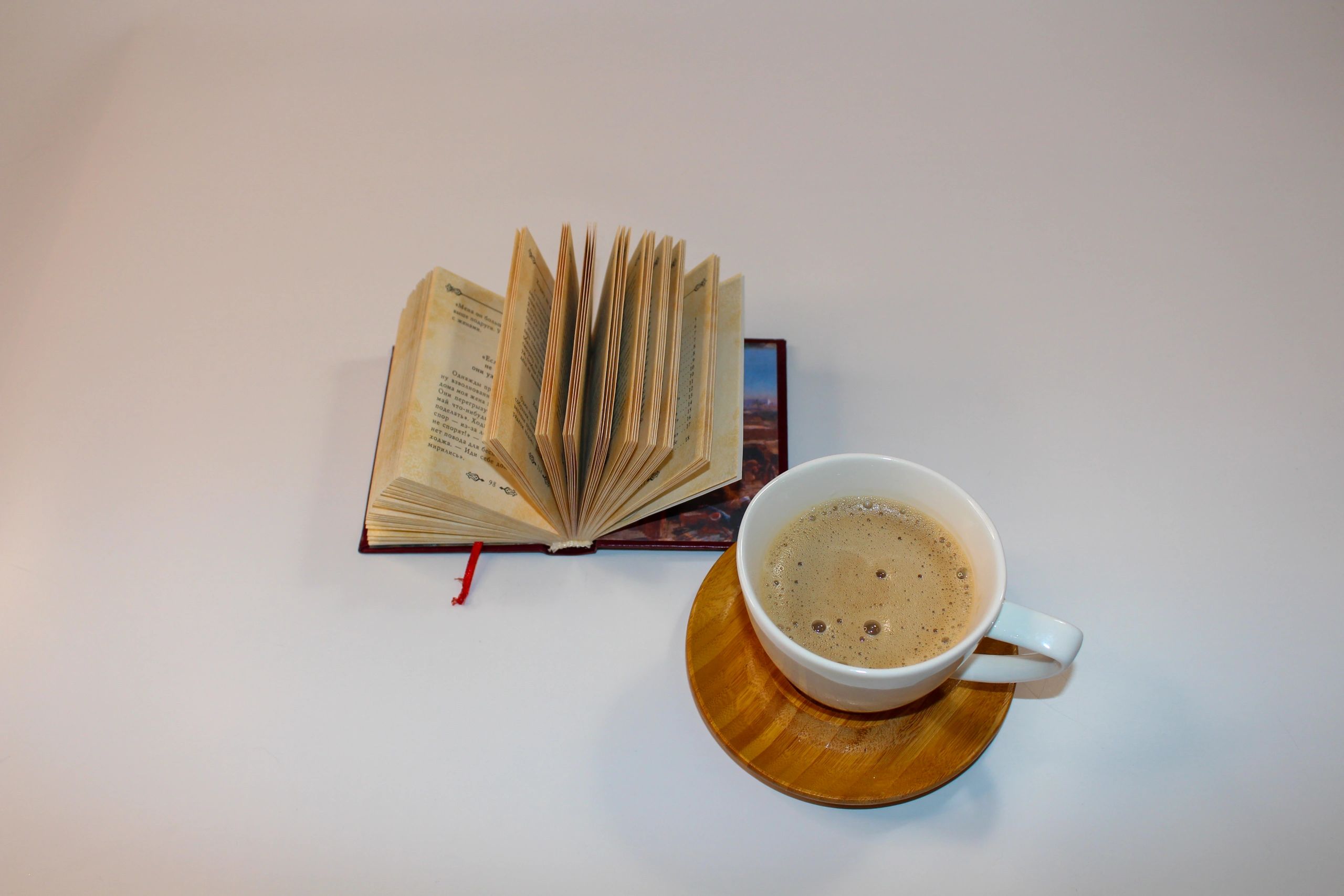 Steaming coffee with an open book