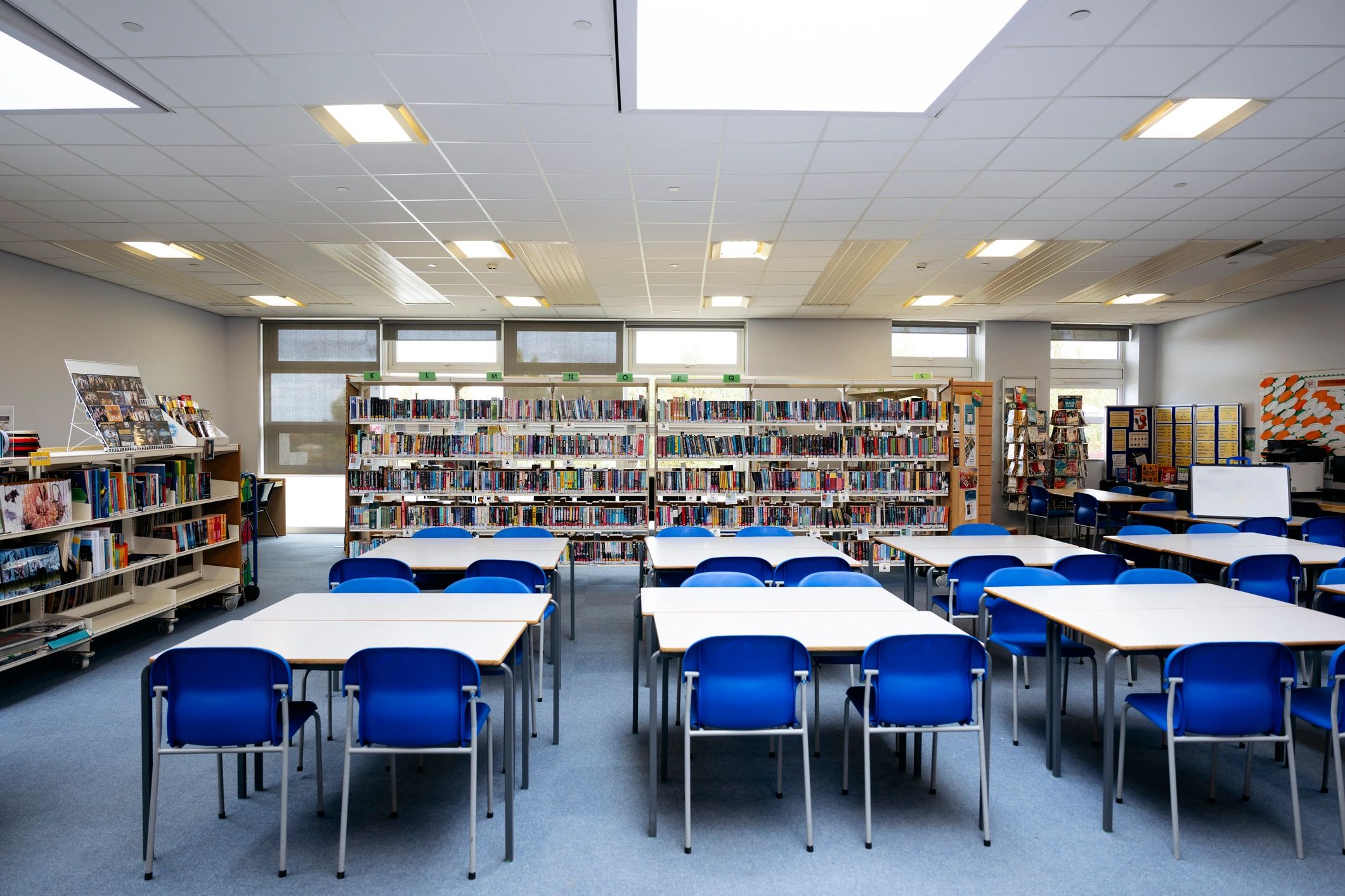 Library interior with bookshelves and reading tables